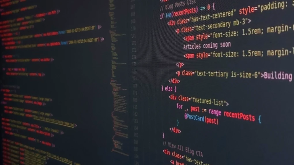 A clean, cinematic photograph of a high-tech software development workspace.